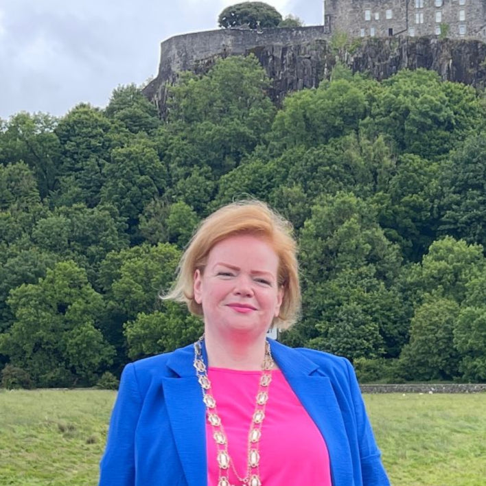 Woman in a blue suit standing in front of Stirling Castle